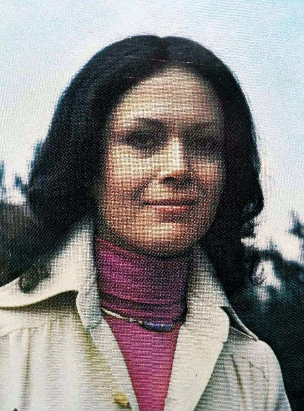 Parissa outdoors in a magenta turtleneck and light coat — portrait from her formative and early professional years, 1970s